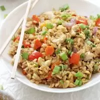 Make thai-style pineapple chicken fried rice at home! Simple, easy to make and much healthier than take-out! Packed with fresh veggies, brown rice, scrambled eggs and cashews!