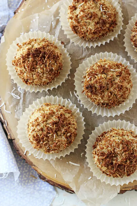 Several Coconut Milk Muffins on a wooden platter.