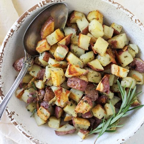 Crispy, creamy roasted red potatoes! This simple side is a perfect addition to any meal! With garlic, rosemary and thyme!