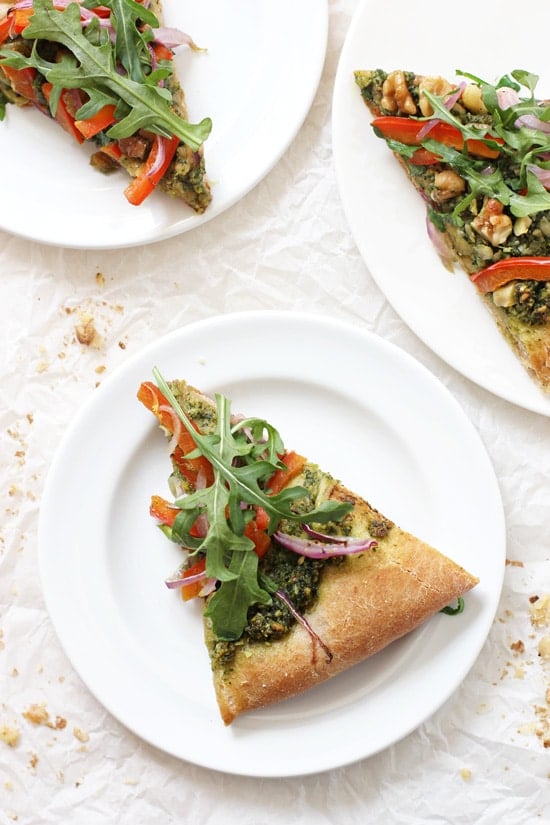 Three slices of Wheat Pizza on white plates.