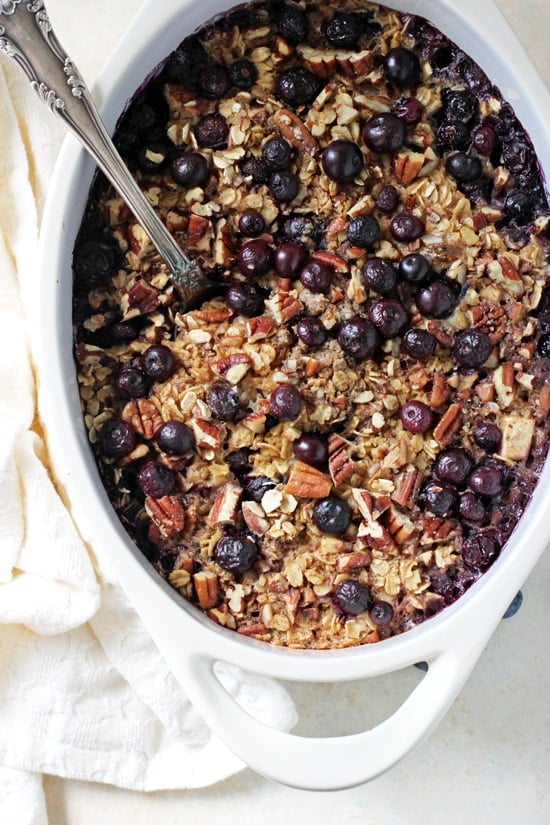 A white baking dish filled with Baked Blueberry and Apple Oatmeal.