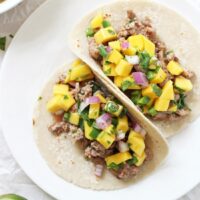 25 minute ground pork tacos with mango salsa! Easy, healthy and delicious! These simple tacos are on the table in a flash! Sweet, spicy and totally fresh!