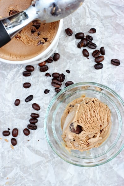 A bowl and white container filled with Mocha Chocolate Chip Ice Cream.