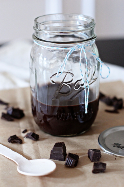 A glass jar filled with Homemade Hot Fudge.