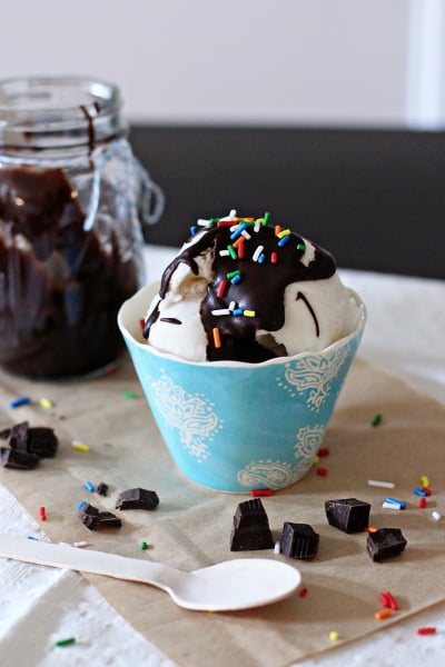 Homemade Hot Fudge Sauce drizzled on a bowl full of ice cream.