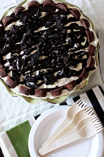 A Peanut Butter Oreo Ice Cream Pie with plates and forks to the side.