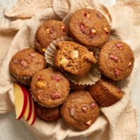 A cloth-lined basket filled with Dairy Free Apple Cinnamon Muffins.
