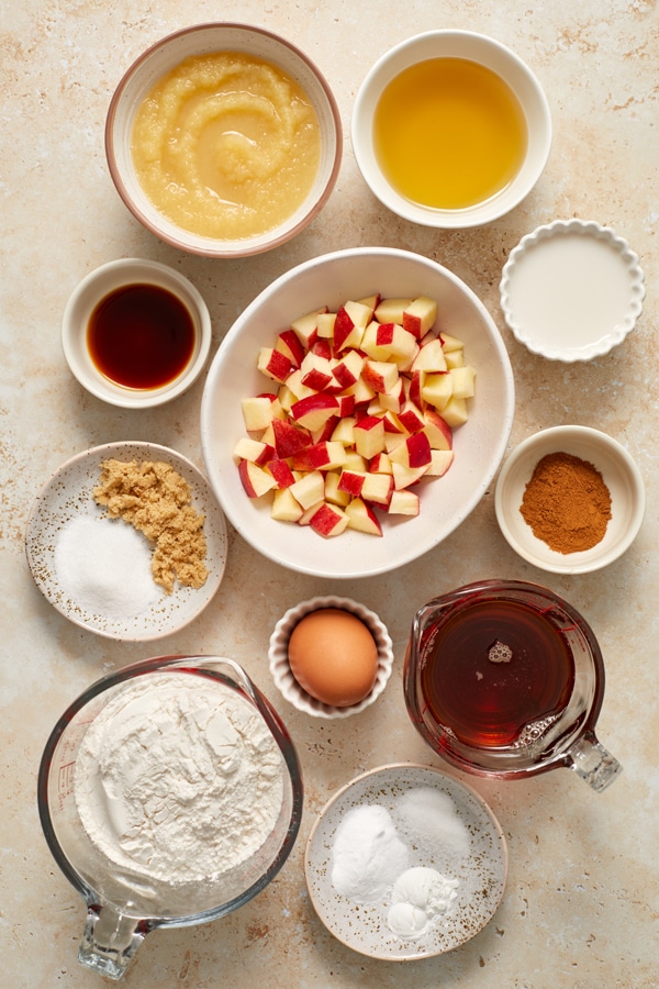 Ingredients for apple cinnamon muffins in small bowls.