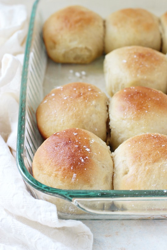 A glass baking dish filled with Honey Yeast Rolls.