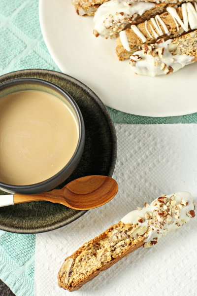 Several Maple Pecan Biscotti with a cup of coffee.