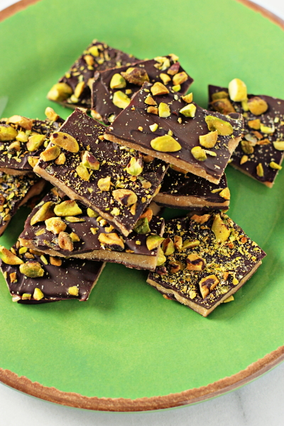 A green plate filled with Dark Chocolate Toffee.