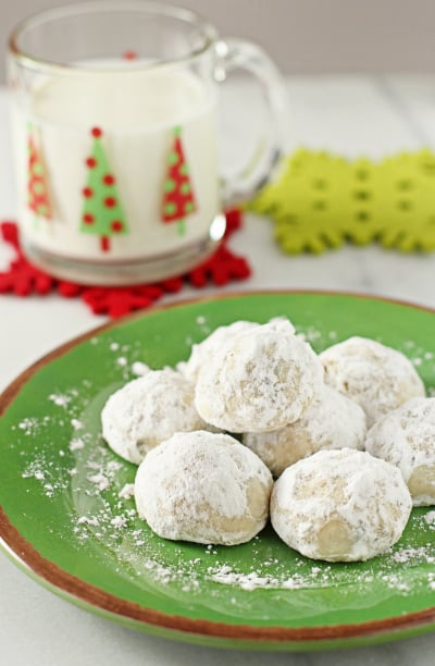 Snowball Cookies with Mini Chocolate Chips on a green plate.