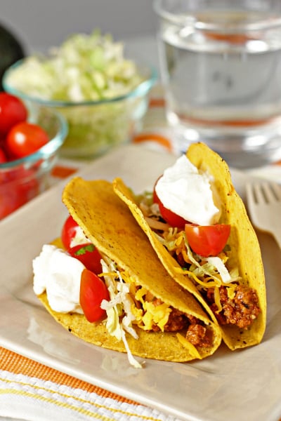 Two Healthy Turkey Tacos on a beige plate.