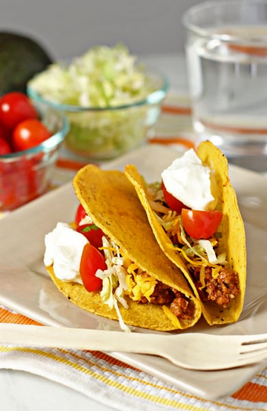 Two Ground Turkey Tacos on a plate with a fork.