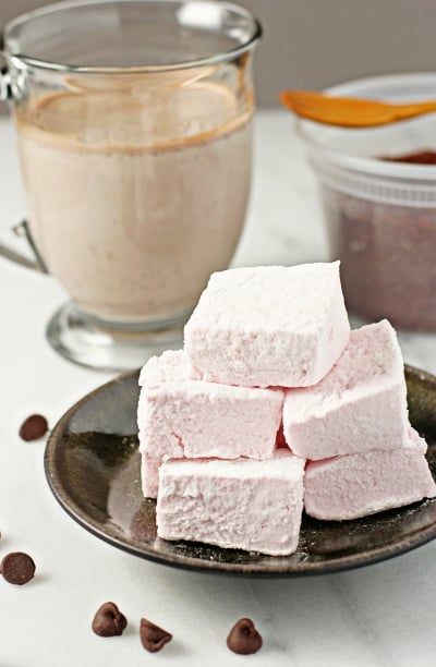 Several Homemade Raspberry Marshmallows stacked on a plate.