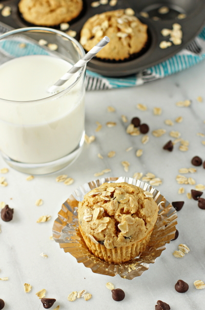 A Peanut Butter Chocolate Chip Muffin with a glass of milk.