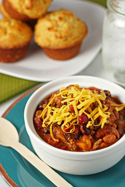 A bowl of Beef and Sausage Chili with a spoon to the side.