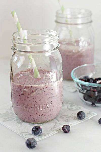 Two ball jars filled with Blueberry and Peanut Butter Smoothie.