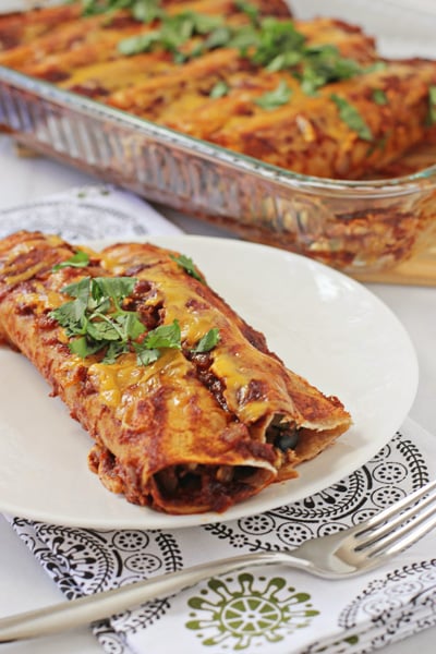 Two Chicken and Vegetable Enchiladas on a plate.