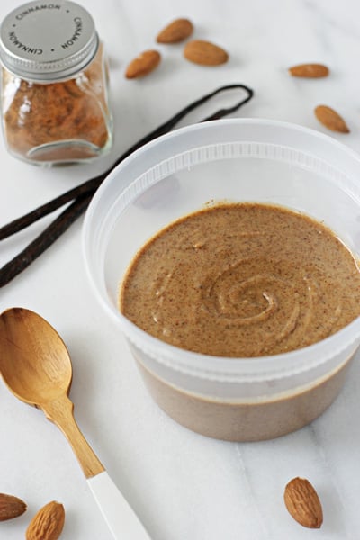 A plastic container filled with Vanilla Cinnamon Almond Butter.