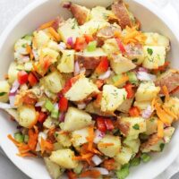 Crunchy, creamy and packed with flavor, this dairy free potato salad is perfect for summer parties and potlucks! With fresh veggies and a dreamy maple mustard dressing, there’s no mayo involved! Gluten free & vegan.