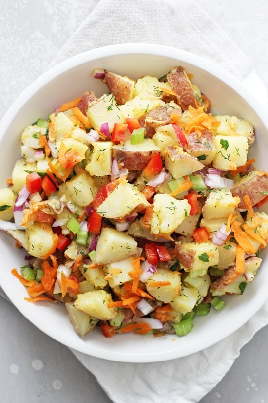 A white bowl filled with Dairy Free Potato Salad.