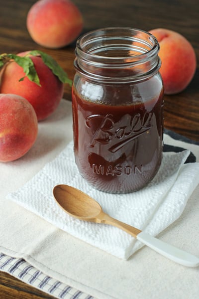 A glass jar of Peach Chipotle Barbecue Sauce.