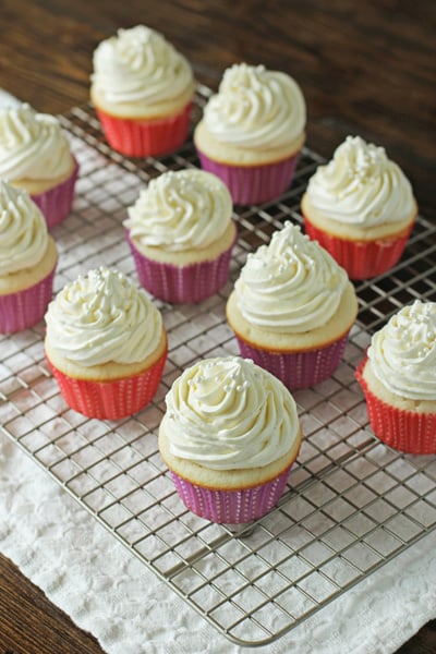 Double Vanilla Cupcakes on a wire cooling rack.