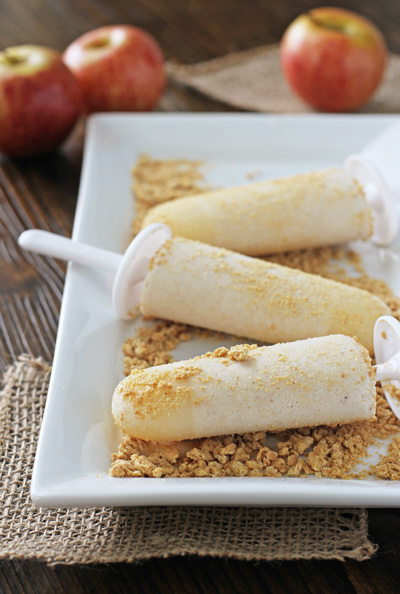 Three Apple Pie Popsicles on a white serving dish.