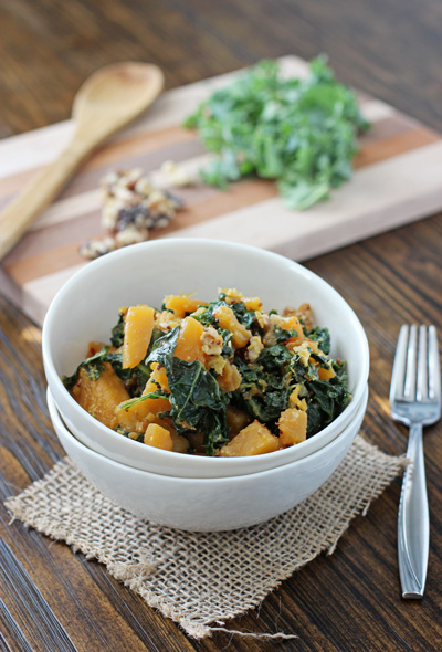 Two stacked white bowls filled with Mustardy Kale and Butternut Squash.