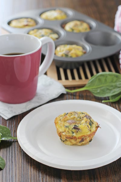 A Spinach Frittata Muffin on a plate with more in the background.