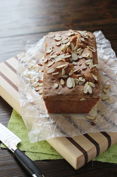 An Almond Pound Cake on a wooden cutting board.