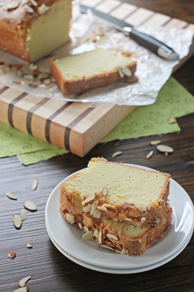 Two slices of Almond Flavored Pound Cake on a white plate.