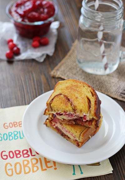 A Cranberry Bacon Grilled Cheese sandwich on a white plate.
