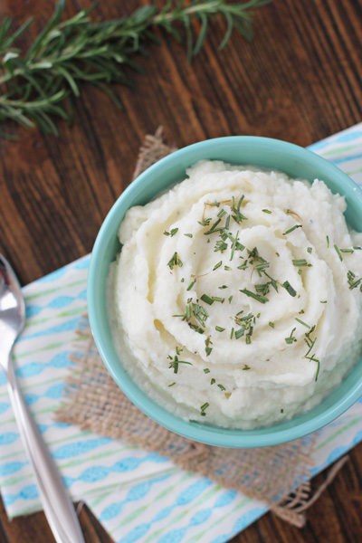 A serving bowl filled with Cream Cheese Mashed Cauliflower.