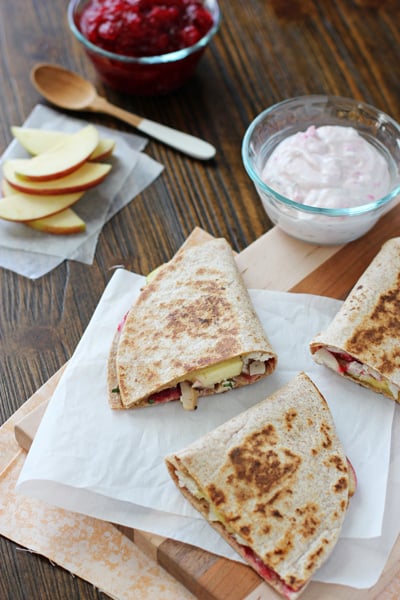 A sliced up Leftover Turkey Quesadilla on a wood cutting board.