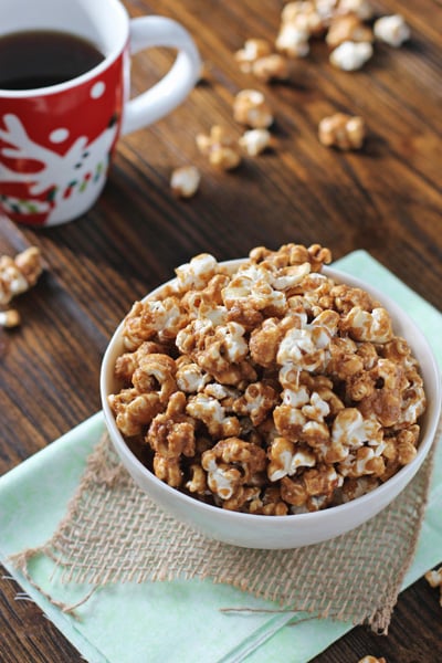 A white bowl filled with Gingerbread Popcorn.