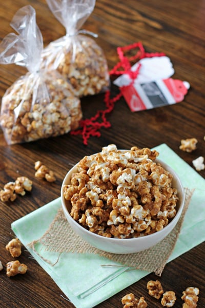 A bowl and two bags filled with Gingerbread Caramel Corn.