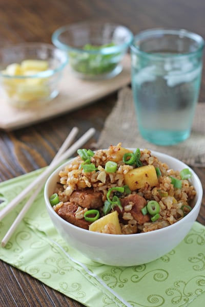 A white bowl filled with Pineapple Pork Fried Rice.