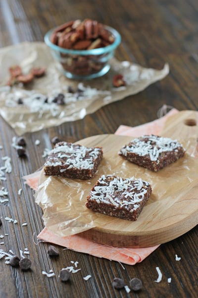 Three Brownie Snack Bars on a wooden cutting board.