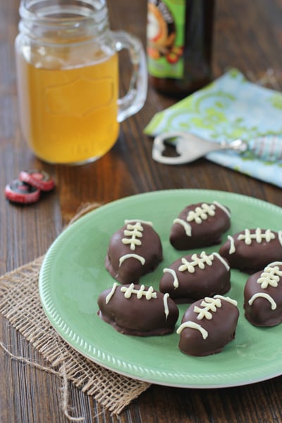 A green plate filled with Oreo Football Truffles.