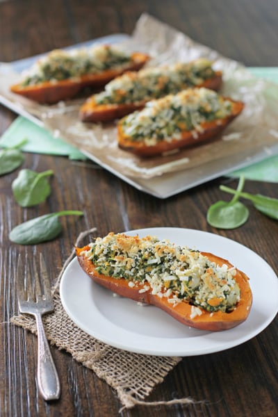 A Spinach and Artichoke Sweet Potato Skin on a white plate with a fork.