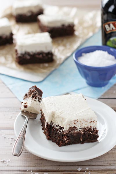 A Beer Brownie on a white plate with a bite taken out with a fork.