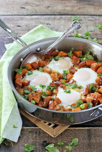 A Southwest Sweet Potato Breakfast Skillet on a wooden surface.