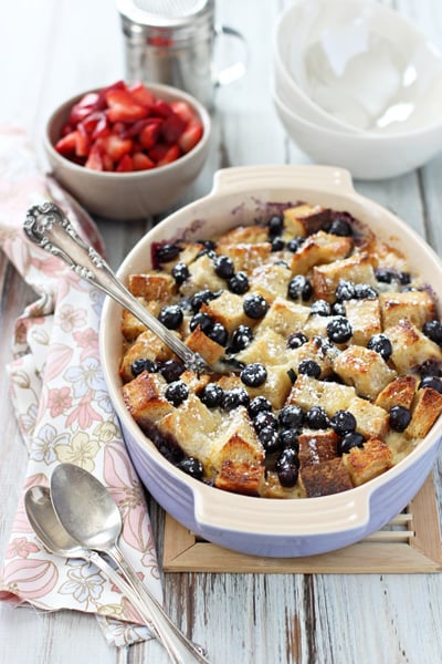 A purple baking dish filled with Berries and Brie Breakfast Bake.