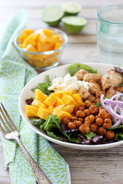 Chicken Mango Salad in a white bowl with a fork to the side.