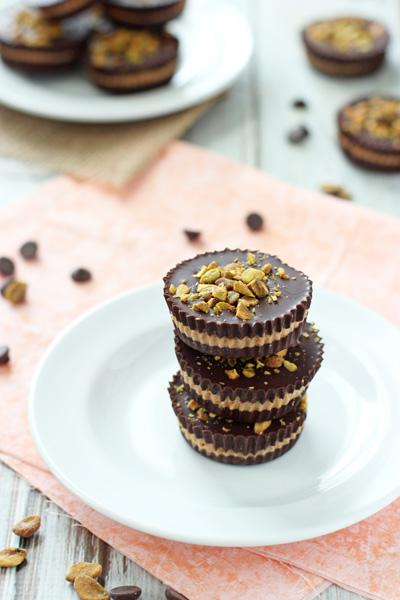Three Almond Butter Cups stacked on a white plate.