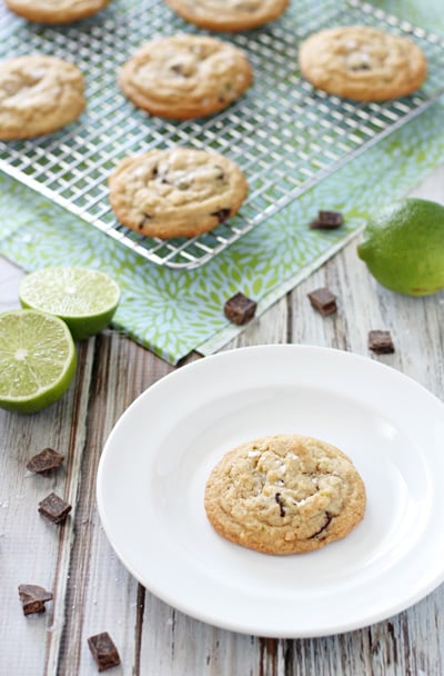 A Chocolate Lime Cookie on a white plate with more in the background.