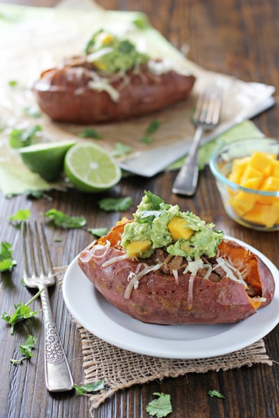 Two Pulled Pork Sweet Potatoes topped with mango guacamole.