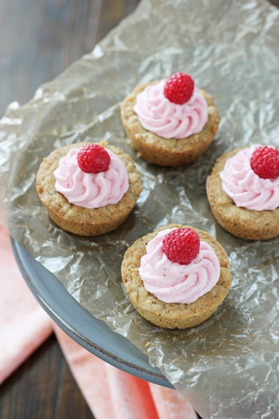 Four Poppy Seed Cookie Cups on a grey cake stand.